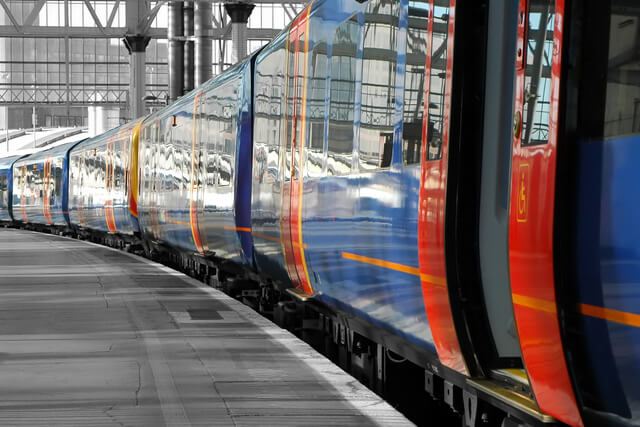 A train pulled up at a station with the doors open