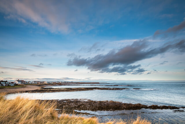 A view from the sand dunes across the water at Beadnell Bay