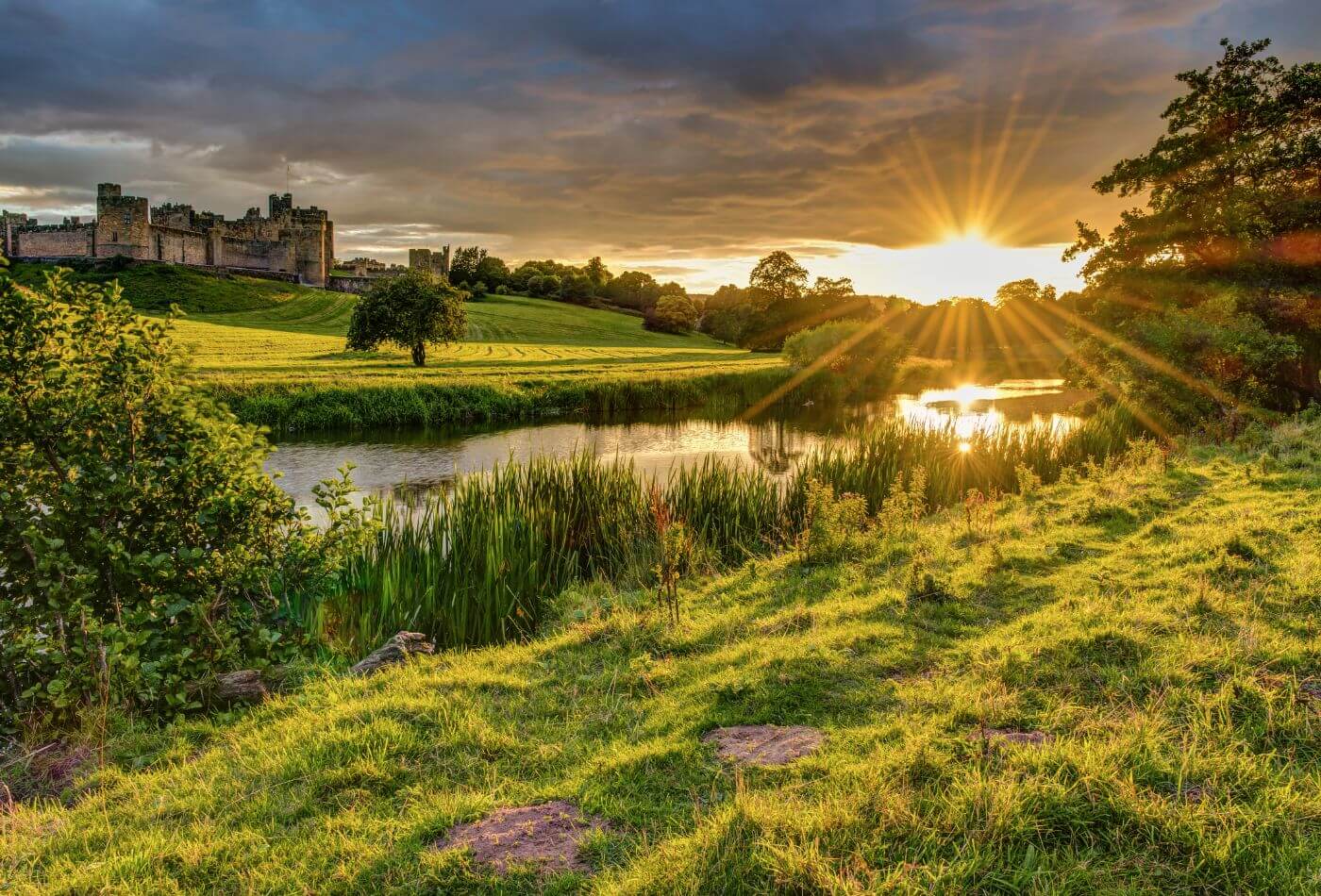 view of alnwick castle as the sun is rising