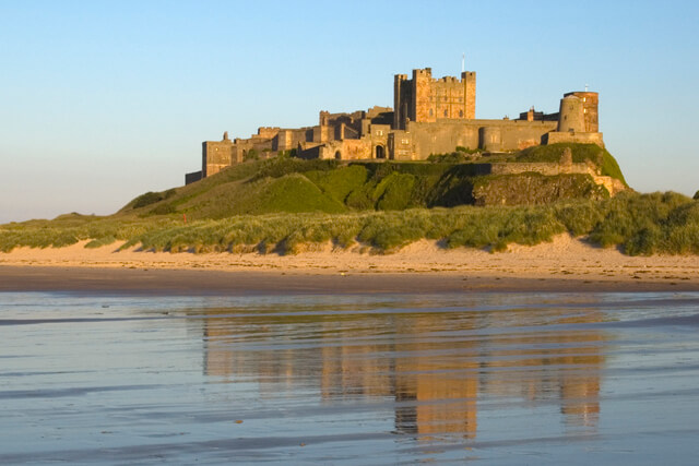 Bamburgh Castle and its reflection in the water