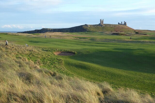 Dunstanburgh Castle Golf Course with the castle beyond the fairway in the distance 