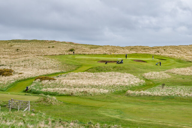 Golfers on the green at Goswick Links Golf Course