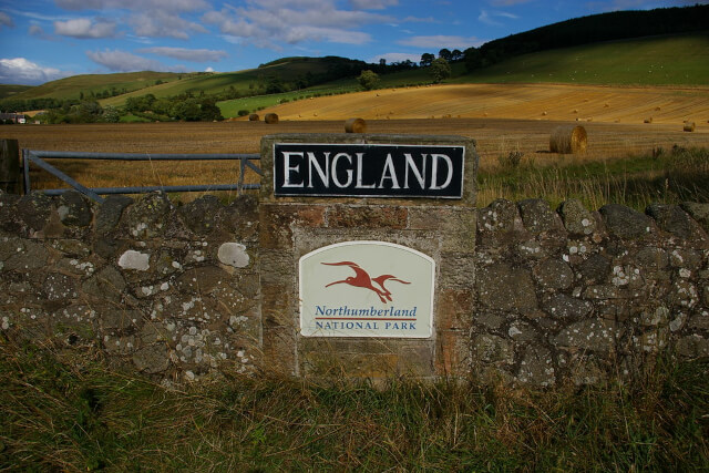 Border Road Sign to Northumberland National Park with the countryside in the background 